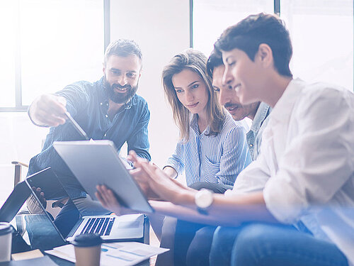 People in a meeting on a tablet.